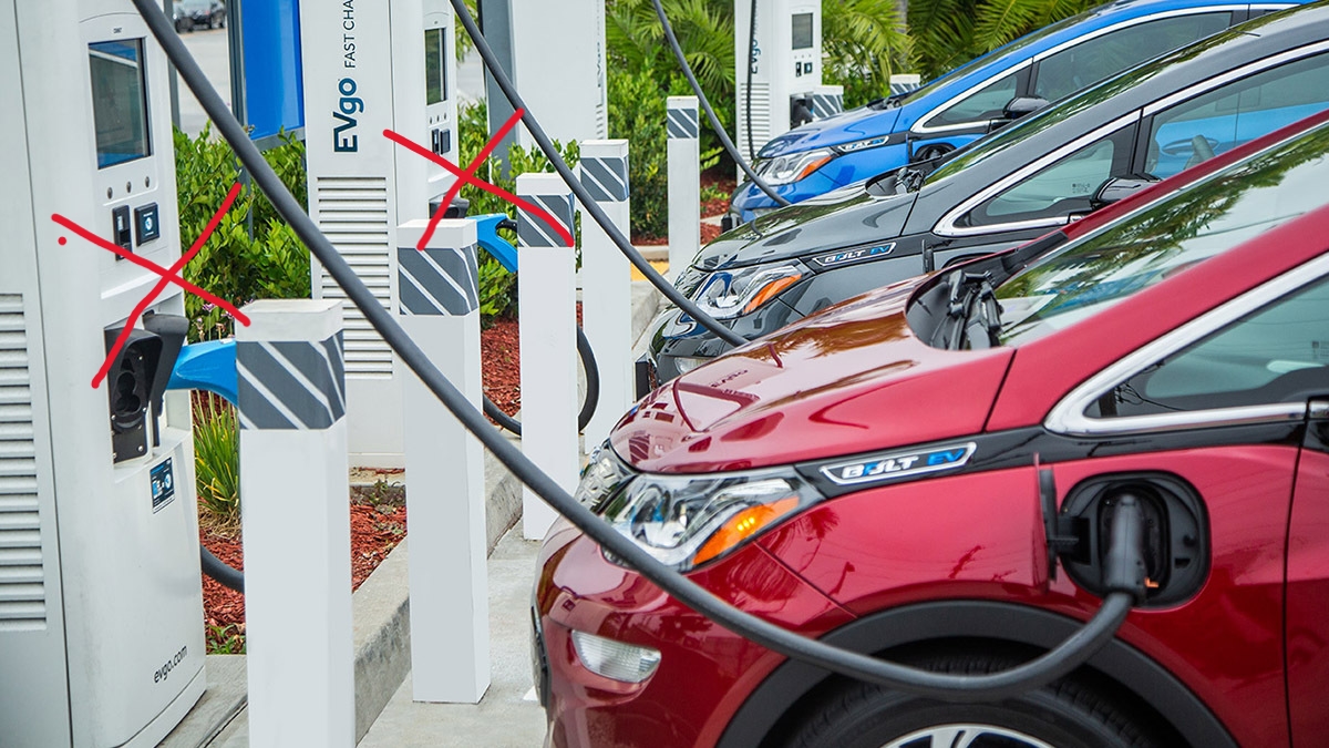 A row of cars are parked at the gas station.